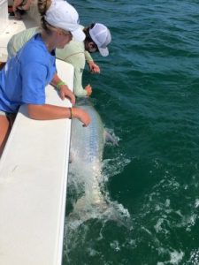 Captain Logan Bystrom lands a tarpon for Ruth Marsh.