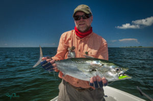 Man holds a bonito, a type of tuna.