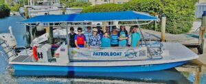 Young people pose on a boat owned by Suncoast Waterkeeper.