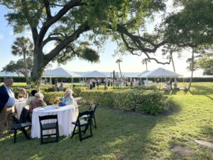 Supporters of Sarasota Bay enjoy an afternoon at tables on the lawn of Bill and Debbie Partridge’s home. - Rusty Chinnis | Sun