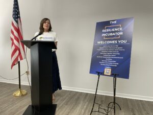 A woman speaks at a podium.